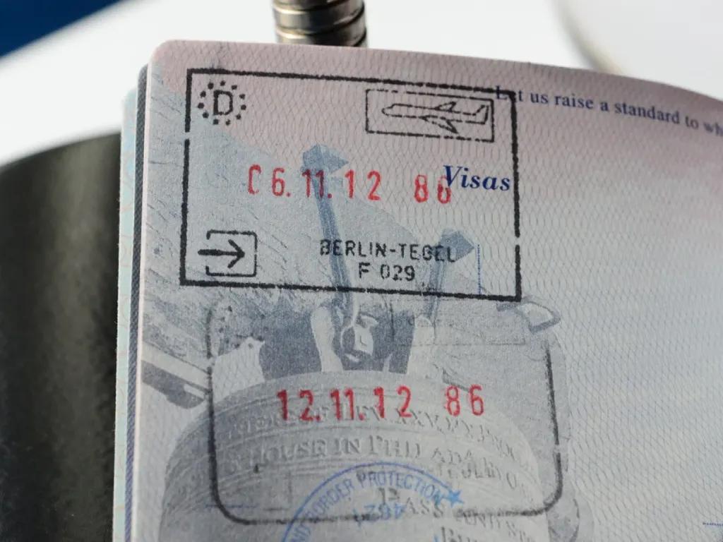 Passport with visa stamps and documents prepared for a Thai bank account application on a DTV visa
