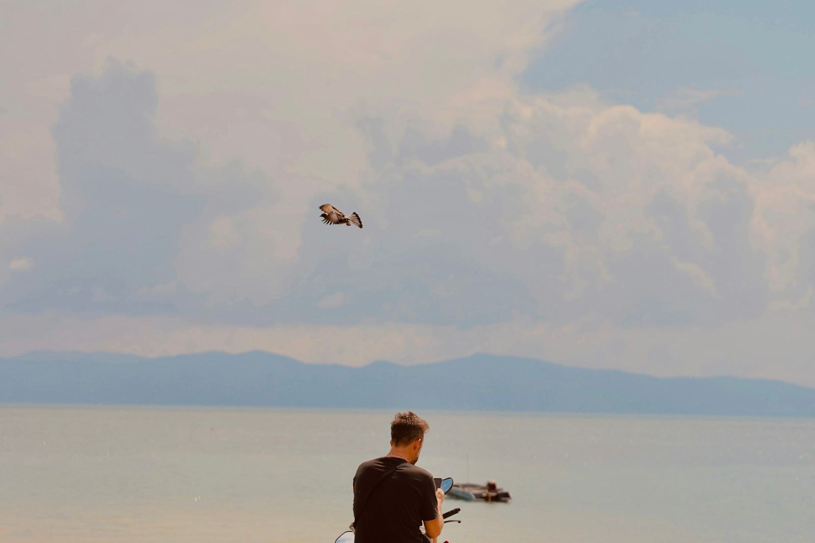 A rider on a scooter by the sea in Phuket, the main way to get around most areas expats live in