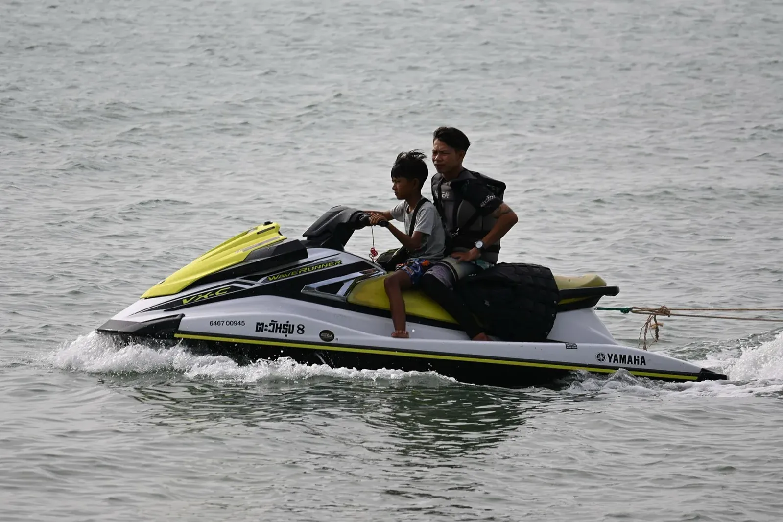 Jet ski riders on calm water, illustrating the jet ski scam in Phuket to avoid