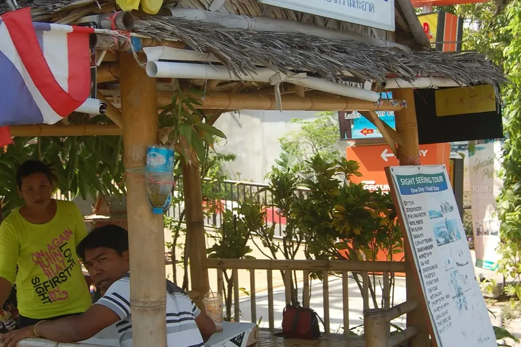 A row of tuk-tuks at a stop in Phuket where tuk-tuk overcharging scams happen