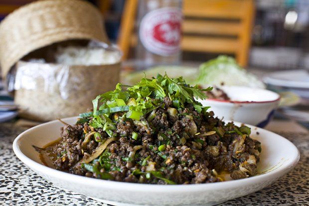 A plate of Thai red ant egg salad topped with fresh herbs