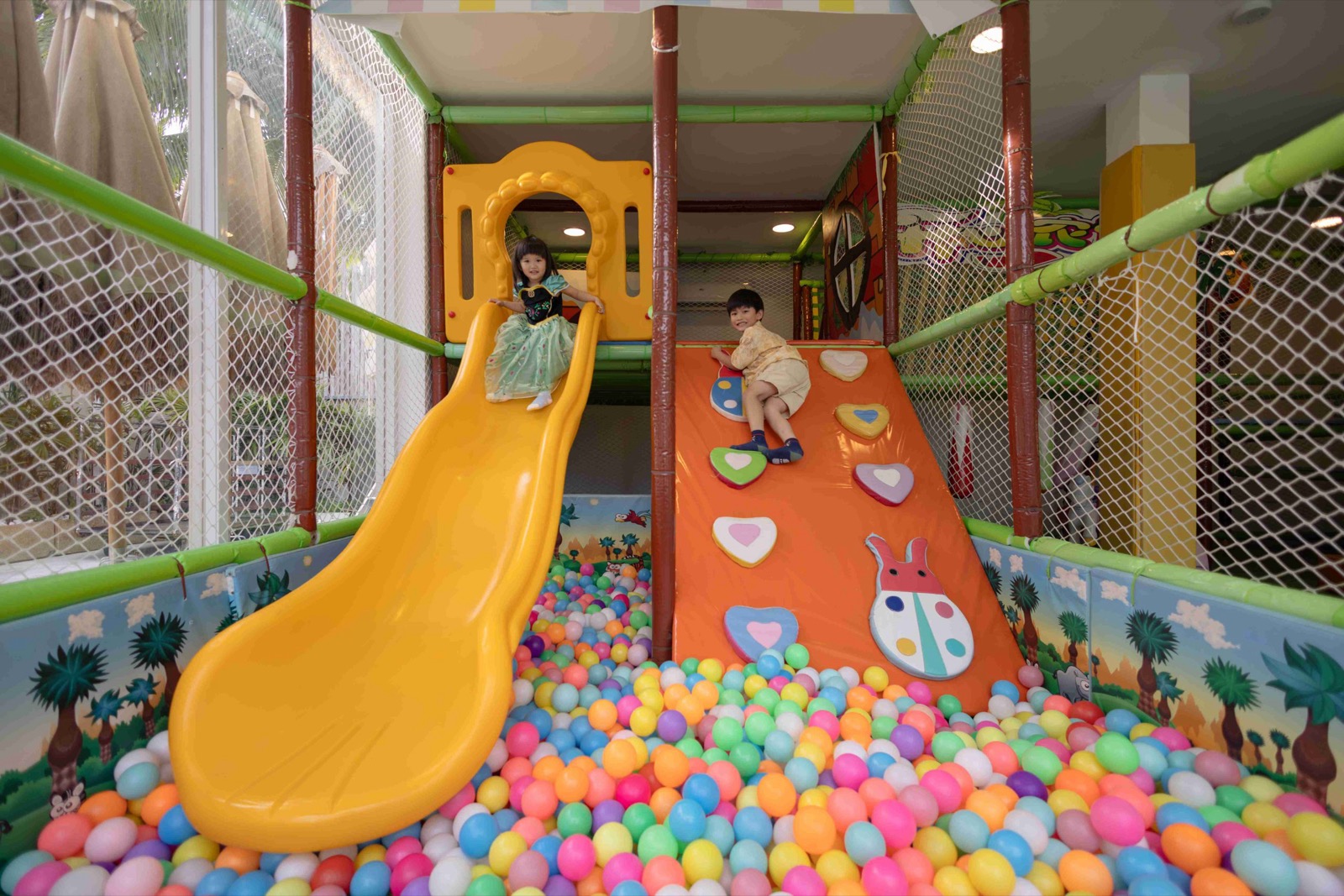 Freeform swimming pool and garden play area at the family friendly Phuket resort