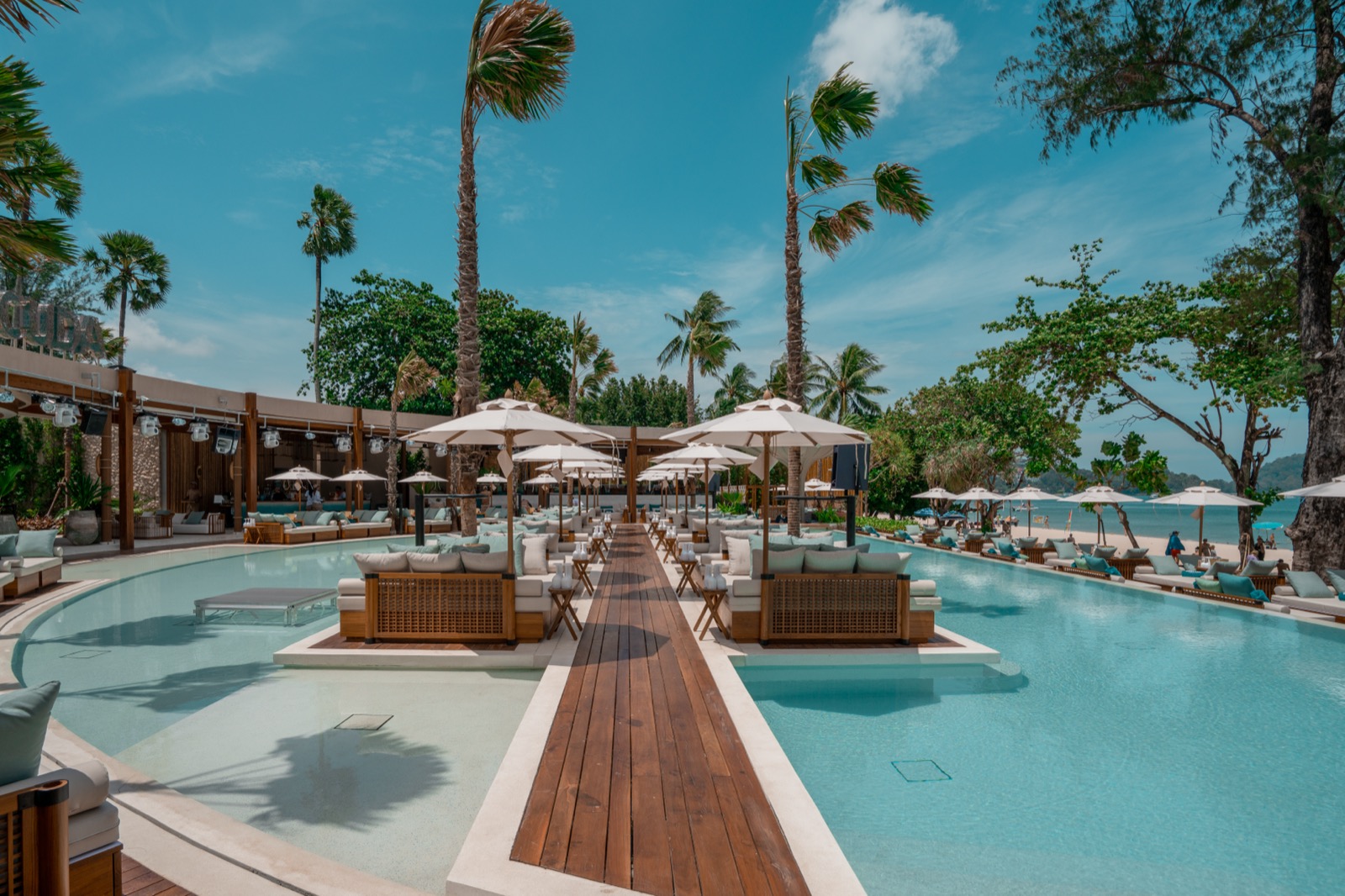 Pools and central boardwalk with day beds at Barra Cuda Beach Club, Patong