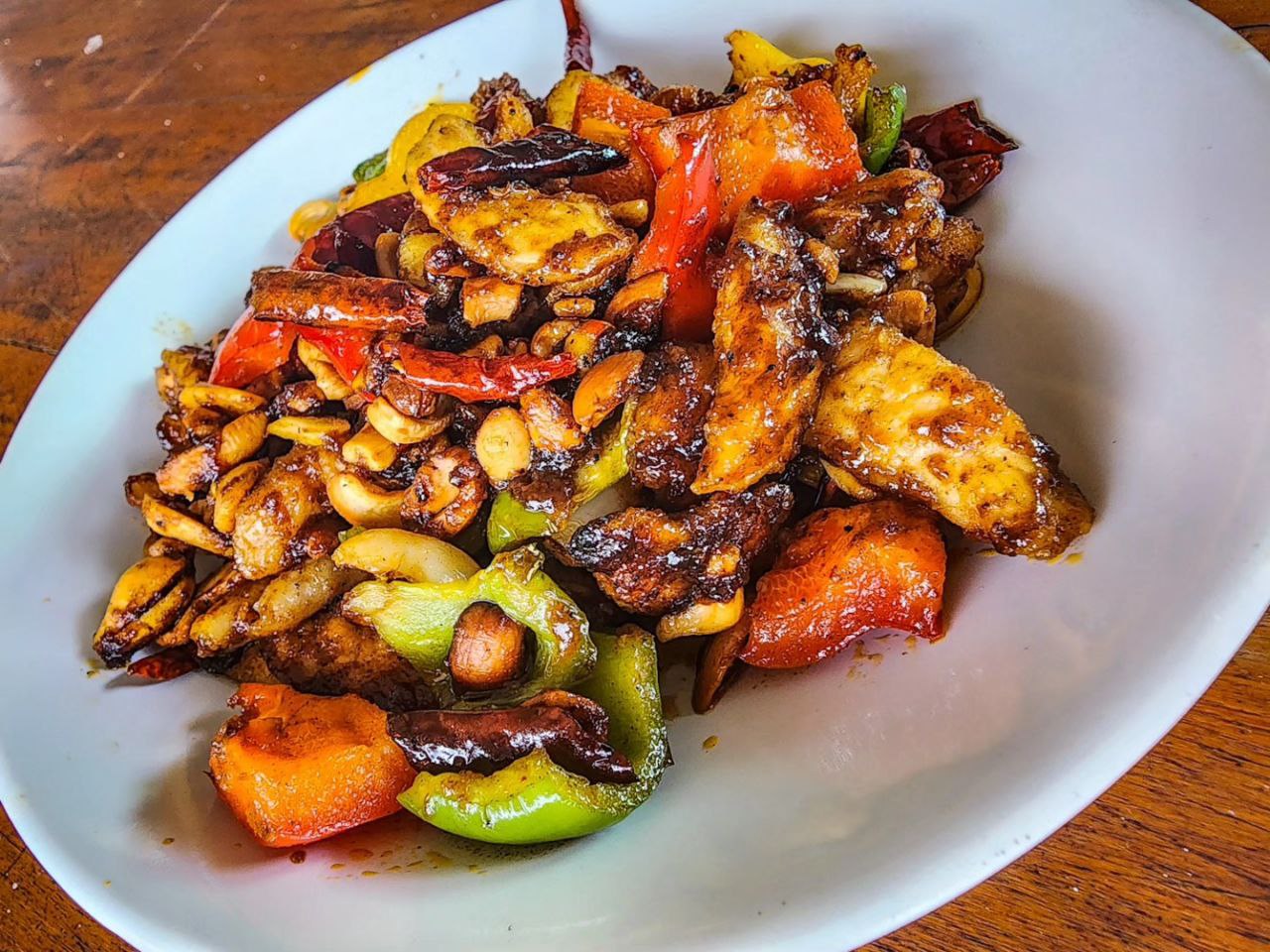 Stir-fried cashew nut chicken with bell peppers and dried chillies at Denz Cafe, a Thai cafe in Patong, Phuket