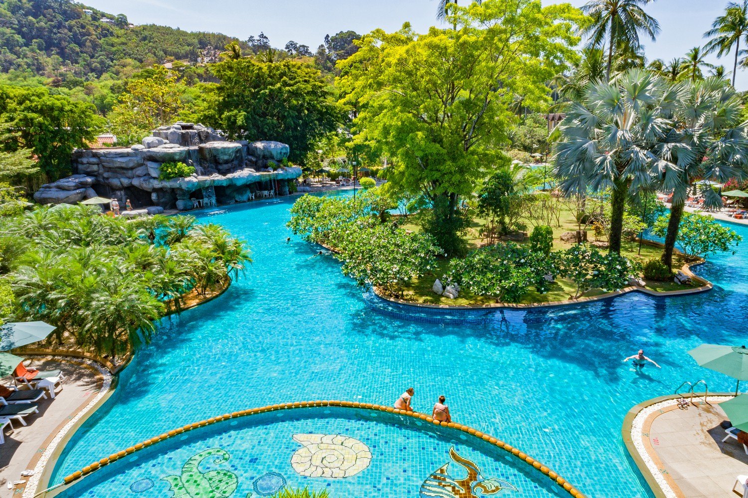 Lagoon-style pool with water slides at Duangjitt Resort & Spa, Patong Phuket
