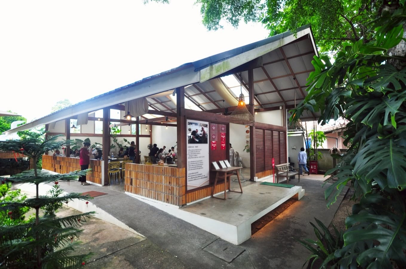Open-air wood and brick pavilion set in tropical greenery at Kin-Kub-Ei, Southern Thai restaurant in Bang Tao, Phuket