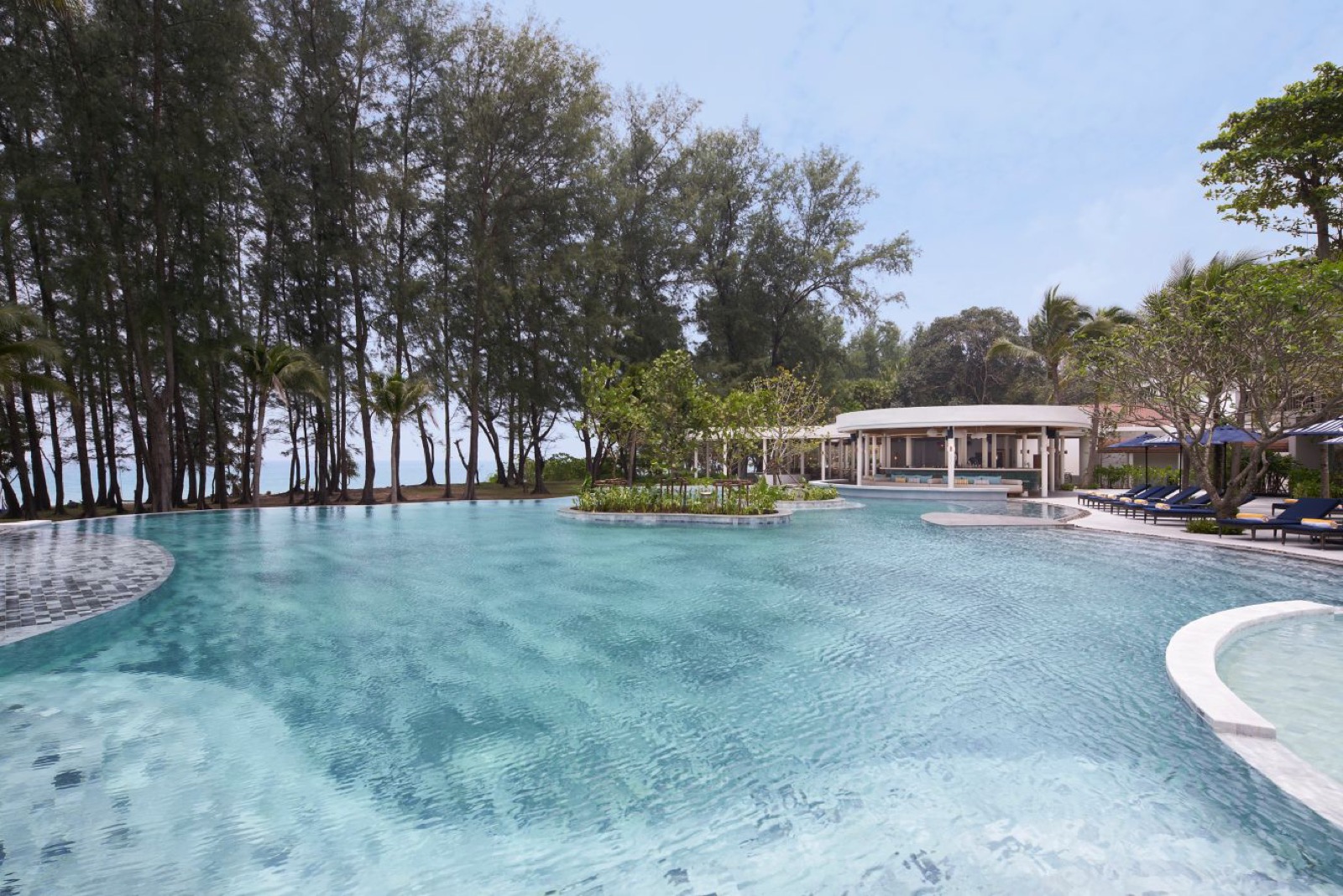 Main outdoor pool with pool bar at Le Meridien Phuket Mai Khao Beach Resort
