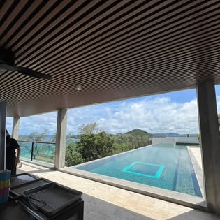 Covered poolside terrace with infinity pool and hillside sea view for Pathongko Mae Pranee off-site catering in Chalong, Phuket