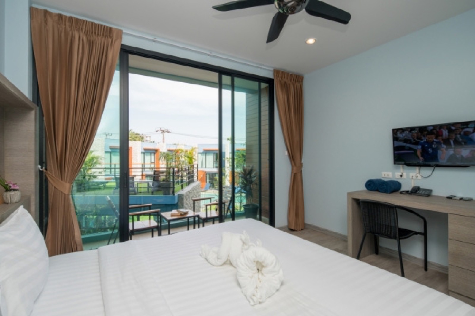 Superior room interior with balcony at Peace Blue Naturist Resort, Nai Harn, Phuket