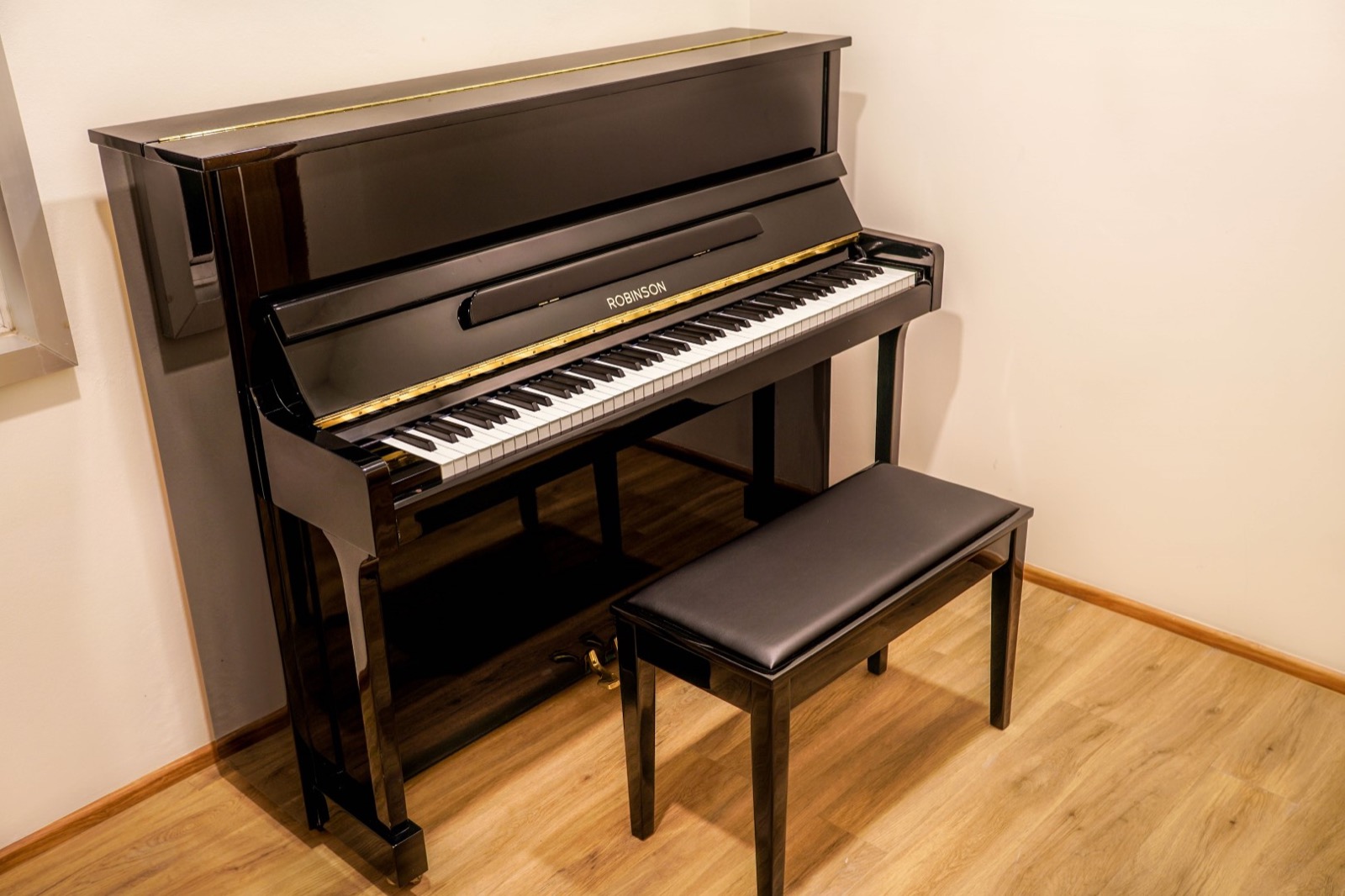 Upright piano and bench in a music lesson room at Phuket School of Music