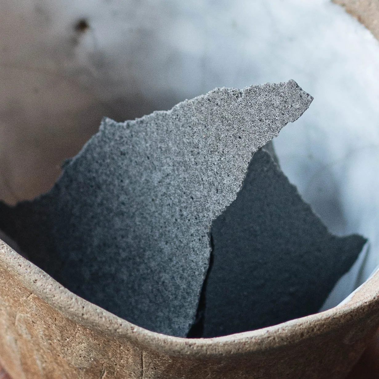 Dark charcoal-coloured cracker served in a rustic ceramic bowl at Royd, a Southern Thai restaurant in Phuket Old Town, Phuket.