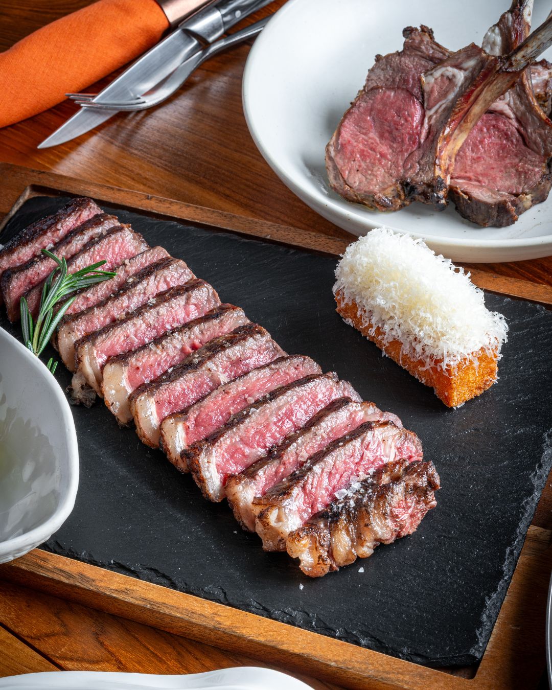 Sliced grilled steak, rack of lamb chops and a parmesan-crusted croquette on slate at Sizzle, a European rooftop restaurant in Patong, Phuket.