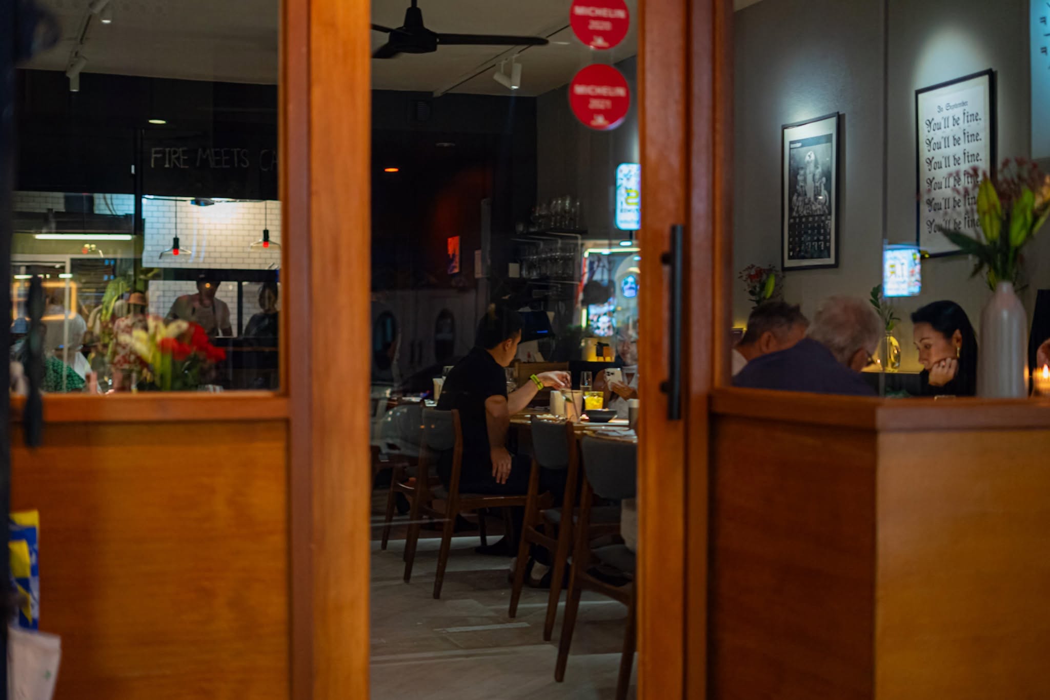 Evening view through the window into the dining room of Surf & Turf by Soul Kitchen, a Michelin restaurant in Phuket Old Town