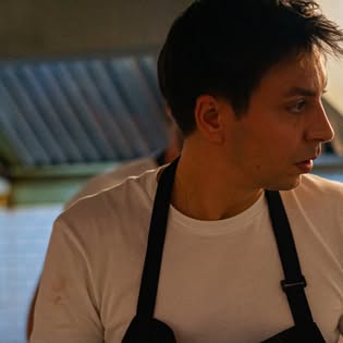 Chef in a dark apron in the kitchen at Surf & Turf by Soul Kitchen, a European restaurant in Phuket Old Town