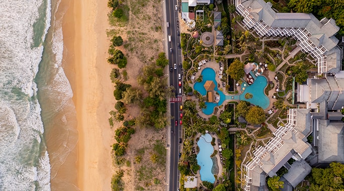 Thavorn Palm Beach Resort aerial view over the pools and gardens at Karon Beach, Phuket