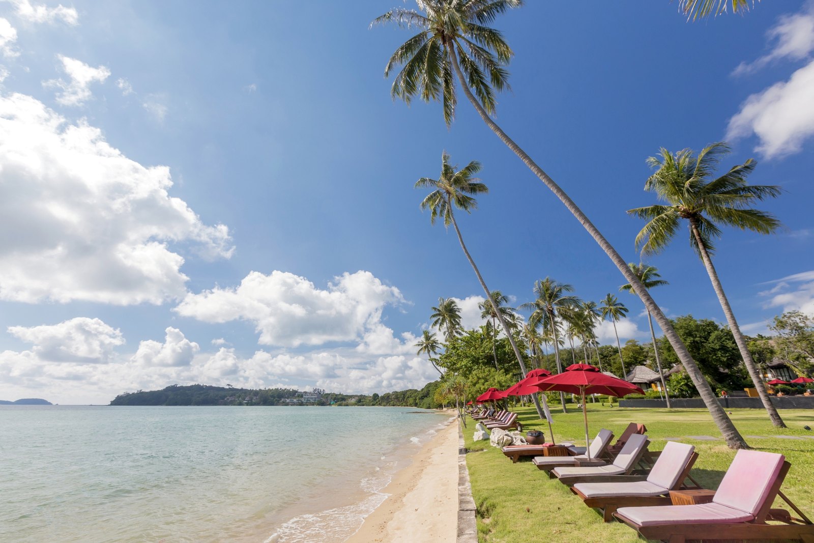Friendship Beach with loungers and palms at The Vijitt Resort Phuket, Rawai